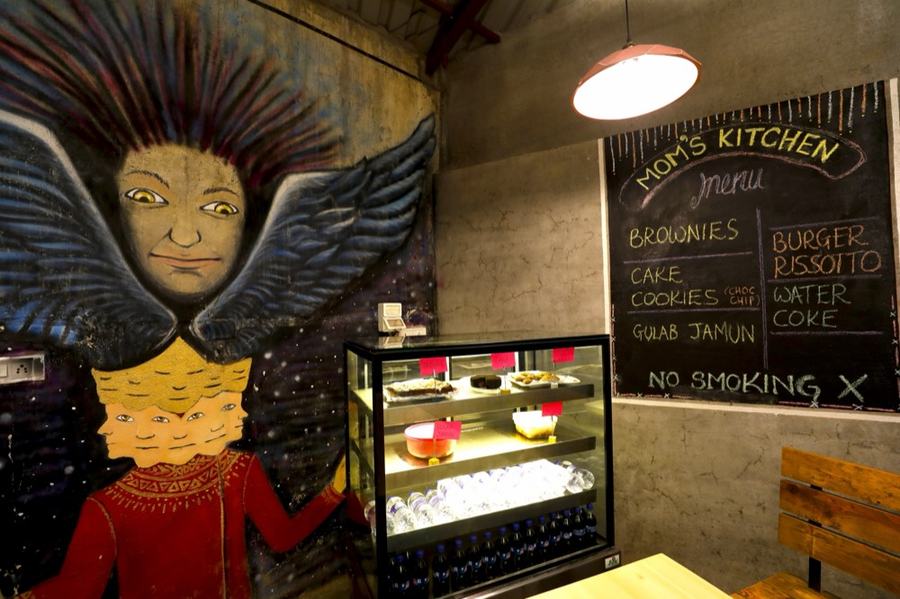 Food counter and chalkboard menu at Nap Manor Hostels